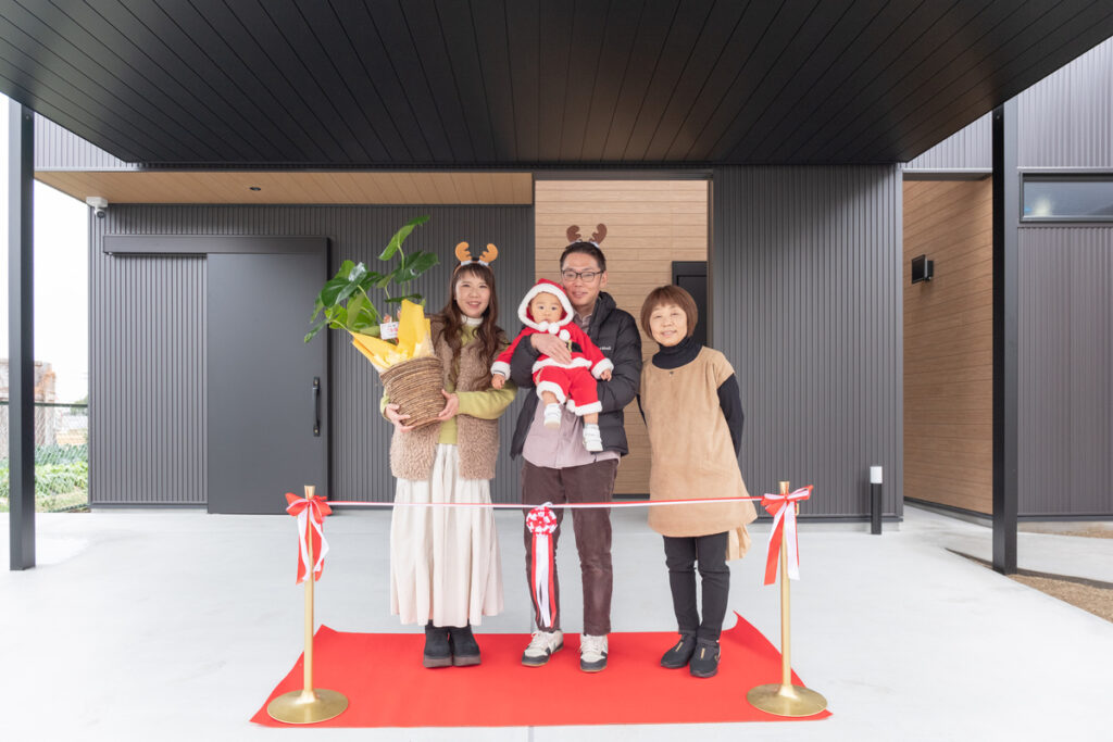 モダンな注文住宅の完成を祝う、ご家族揃ってのテープカット。新しい住まいでの豊かな暮らしのスタートを象徴する、記念すべき引き渡しの瞬間。